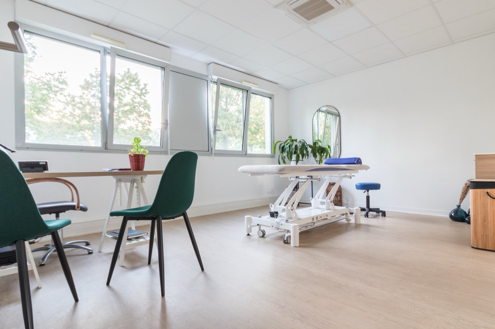 Une salle de soins privative, avec sa table de traitement et son bureau